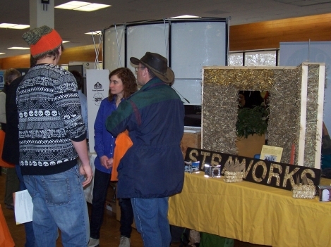 Participants visit displays in the exhibitors’ area at the 2010 Sustainable Living Symposium.