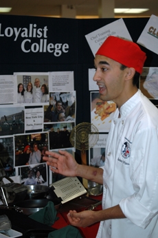 Student Sean Pinto talks to high school students about the Culinary program.
